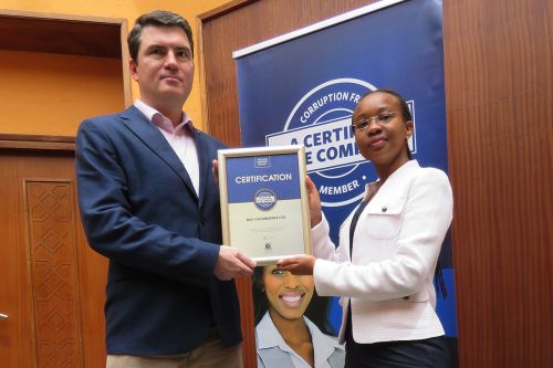 MJS Colourspace Managing Director, Mike Jones receiving the Blue Company Certification from UN Global Compact Network Kenya Coordinator Ms. Judy Njino