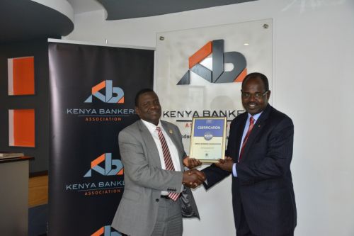 Kenya Bankers Association CEO, Dr Habil Olaka, receiving the Blue Company Certification from Jubilee Holdings CEO/ Executive Board Member of the Blue Company, Dr. Julius Kipngetich