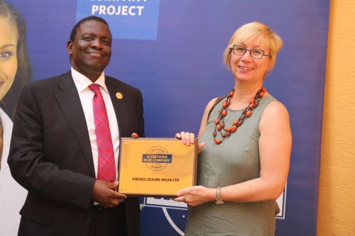 Kiboko Leisure Wear Managing Director, Ms. Sabine Huster, receiving the Blue Company Certification from Jubilee Holdings CEO/ Executive Board Member of the Blue Company, Dr. Julius Kipngetich