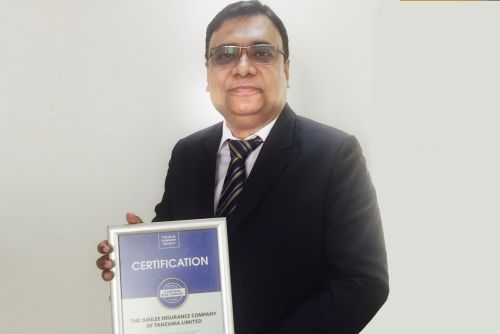 Jubilee Insurance Tanzania General CEO, Depanker Acharya possess for a picture after receiving the Blue Company Certification