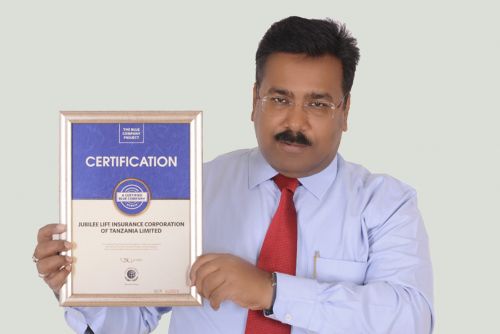 Jubilee Insurance Tanzania Life CEO, Sumit Gaurav possess for a picture after receiving the Blue Company Certification