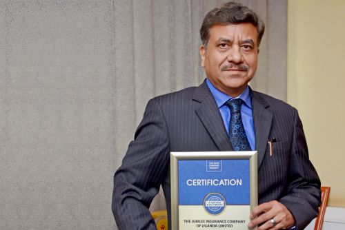 Jubilee Insurance Uganda General CEO, Deepak Pandey possess for a picture after receiving the Blue Company Certification