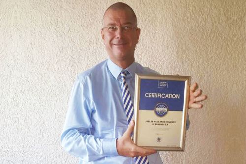 Jubilee Insurance Burundi CEO, Denis Huyberechts, possess for a picture after receiving the Blue Company Certification