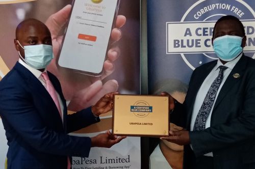 UbaPesa Limited Chief Executive Officer, George Ngabo Wasike, receiving the Blue Company Certification from Executive Advisory Board Member of the Blue Company, Dr. Julius Kipngetich