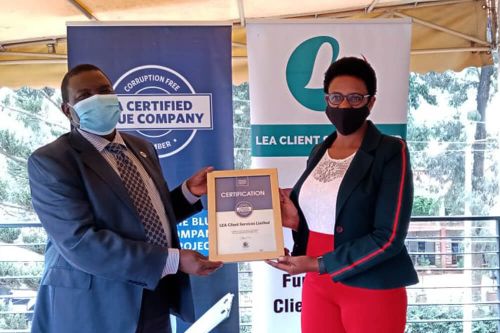 LEA Client services Chief Executive Officer, Wambui Karanja, receiving the Blue Company Certification from Executive Advisory Board Member of the Blue Company, Dr. Julius Kipngetich