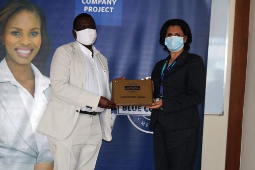 Laser Property Services, General Manager, Shafana Rajani, receiving the Blue Company Certification from Executive Advisory Board Member of the Blue Company, Dr Julius Kipngetich