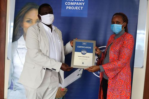 Tilvera Consulting Ltd, Chief Executive Officer, Muthoni Muchai, receiving the Blue Company Certification from Executive Advisory Board Member of the Blue Company, Dr. Julius Kipngetich